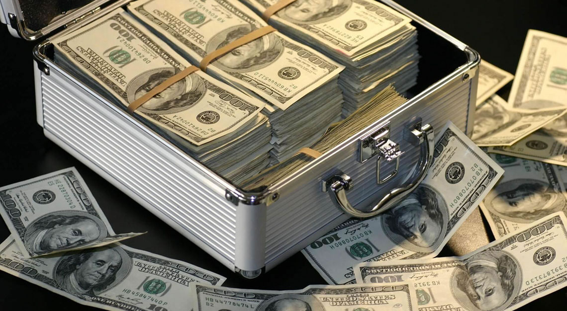 a case with money is standing on a table